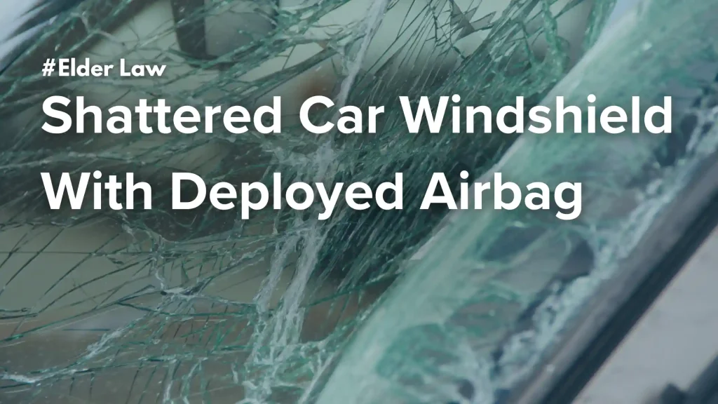 Shattered car windshield with deployed airbag image
